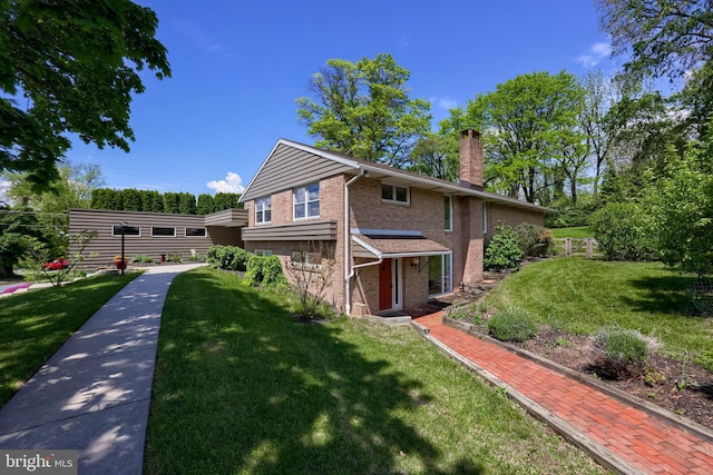 1515 Rockland St, Reading, PA 19604 - view of front of property with brick siding, a chimney, and a front yard