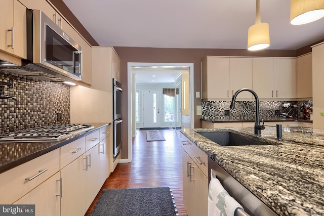 1515 Rockland St, Reading, PA 19604 - kitchen featuring a sink, stainless steel appliances, wood finished floors, and dark stone countertops