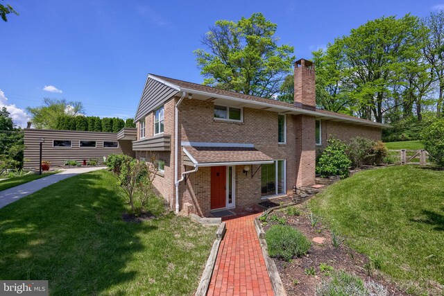 1515 Rockland St, Reading, PA 19604 - traditional home with a chimney, brick siding, and a front yard