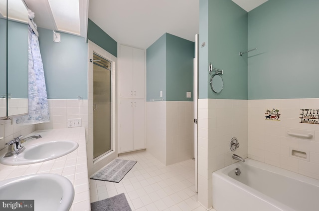 1515 Rockland St, Reading, PA 19604 - full bath featuring a sink, tile patterned flooring, a stall shower, a garden tub, and tile walls
