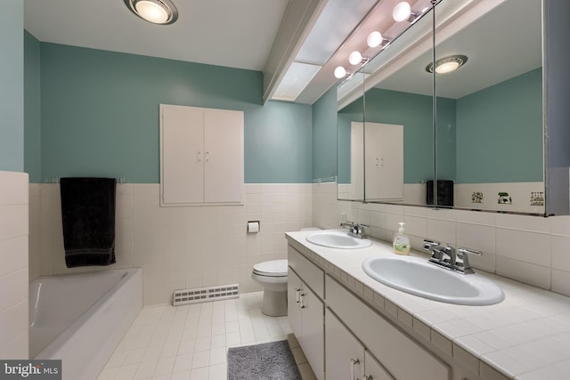 1515 Rockland St, Reading, PA 19604 - full bath with tile patterned floors, tile walls, a wainscoted wall, a tub, and toilet