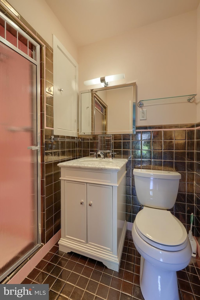 1515 Rockland St, Reading, PA 19604 - bathroom featuring tile walls, tile patterned flooring, toilet, vanity, and a shower stall