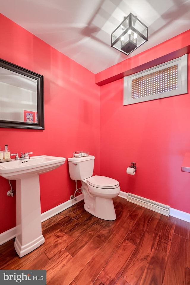 1515 Rockland St, Reading, PA 19604 - bathroom featuring toilet, wood finished floors, baseboards, and a sink
