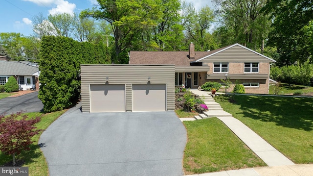 1515 Rockland St, Reading, PA 19604 - tri-level home with asphalt driveway, an attached garage, a front lawn, and brick siding