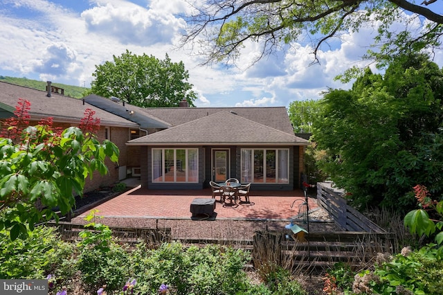 1515 Rockland St, Reading, PA 19604 - rear view of house with a patio area, brick siding, and roof with shingles