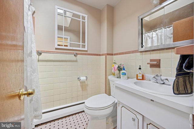 603 Bywood Ave, Upper Darby, PA 19082 - bathroom with tile walls, toilet, vanity, a baseboard radiator, and wainscoting