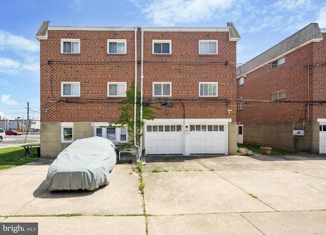 603 Bywood Ave, Upper Darby, PA 19082 - rear view of house with concrete driveway, brick siding, and a garage
