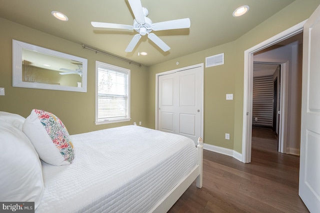 bedroom featuring dark wood-style flooring, visible vents, baseboards, a closet, and recessed lighting