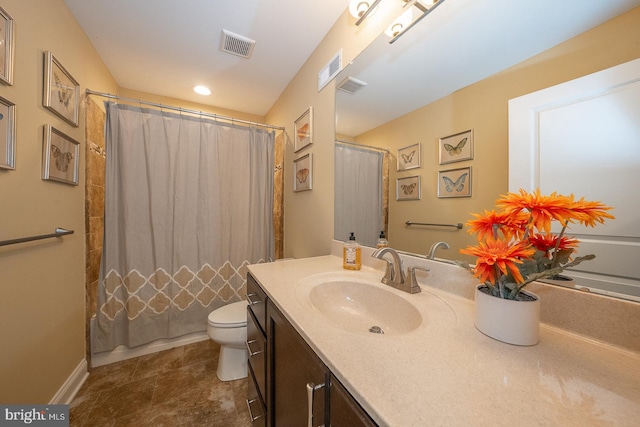bathroom featuring vanity, baseboards, toilet, and visible vents