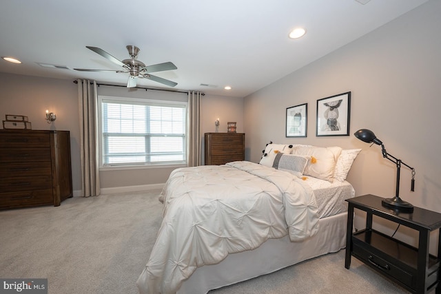 bedroom featuring light carpet, recessed lighting, baseboards, a ceiling fan, and visible vents