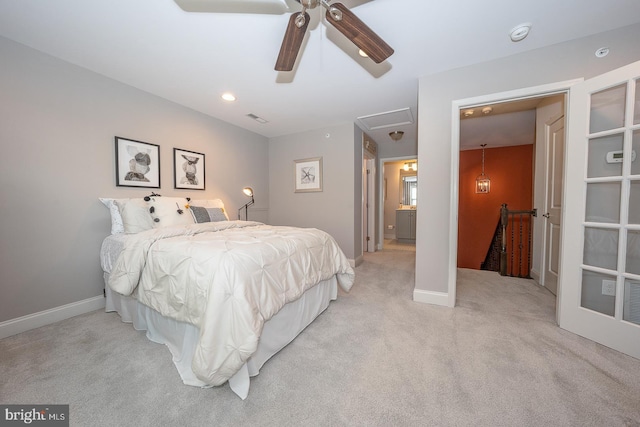bedroom with carpet flooring, ceiling fan, attic access, baseboards, and visible vents