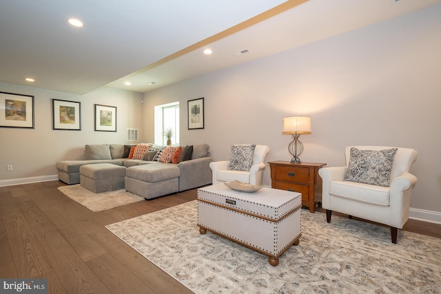 living area featuring baseboards, recessed lighting, wood finished floors, and visible vents