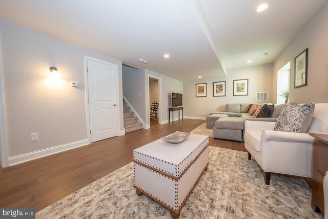 living area featuring recessed lighting, stairs, wood finished floors, and visible vents