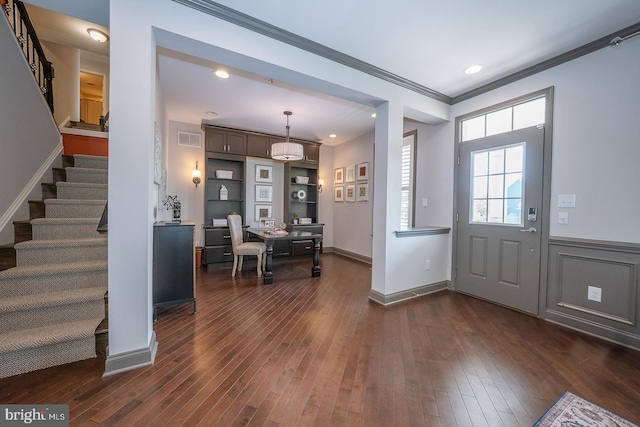 foyer entrance featuring stairway, ornamental molding, dark wood-type flooring, and visible vents