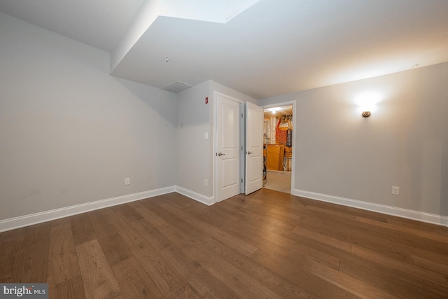 bonus room featuring baseboards and wood finished floors