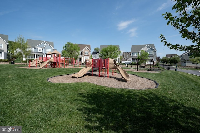 community playground with a lawn and a residential view
