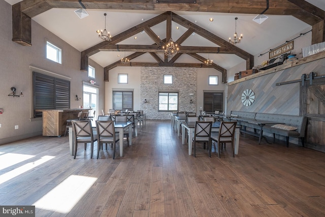 dining space featuring high vaulted ceiling, beam ceiling, hardwood / wood-style floors, and a wealth of natural light