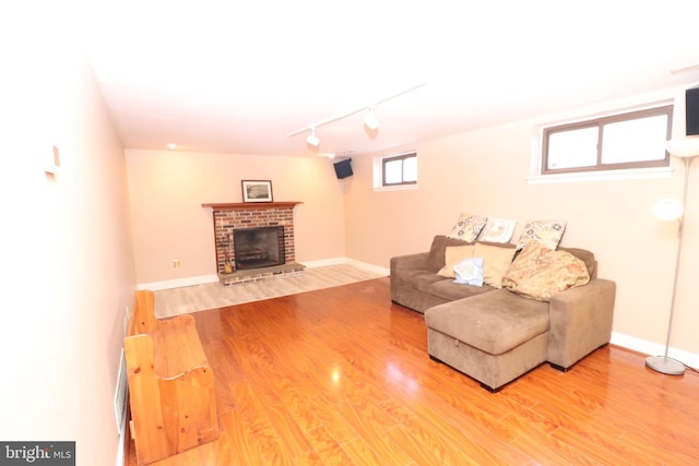 18 Stearrett Dr, Newark, DE 19702 - living area with wood finished floors, rail lighting, a fireplace, and baseboards