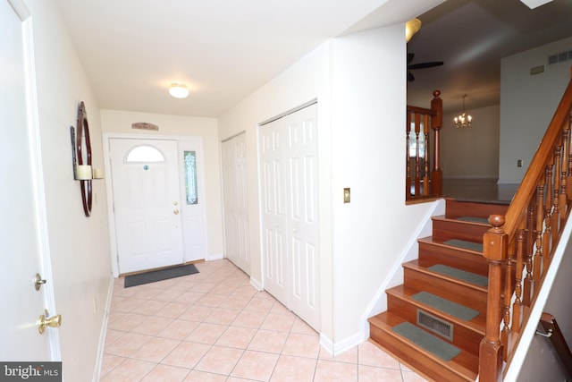 18 Stearrett Dr, Newark, DE 19702 - entryway featuring light tile patterned flooring, stairway, a chandelier, and baseboards