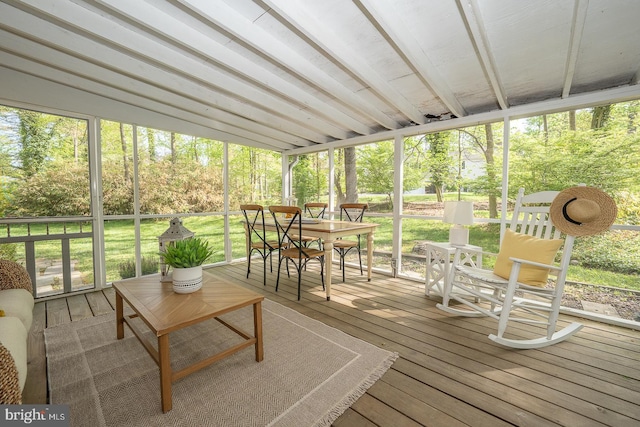 sunroom / solarium featuring a healthy amount of sunlight and outdoor dining space