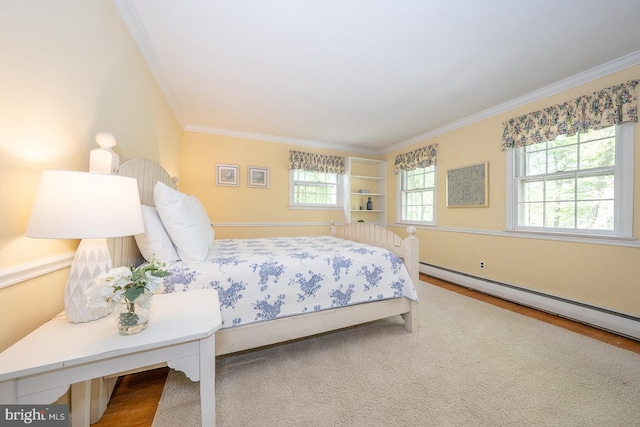 bedroom with ornamental molding, multiple windows, a baseboard radiator, and wood finished floors