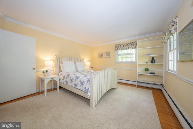 bedroom featuring a baseboard heating unit, baseboard heating, crown molding, and wood finished floors