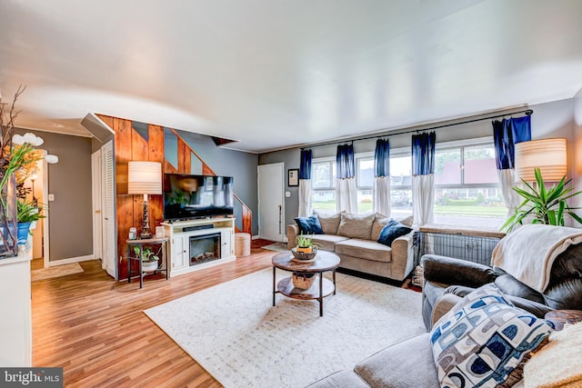 living room featuring light wood-style flooring and baseboards