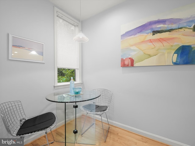 dining area with wood finished floors and baseboards
