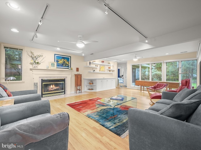 living area featuring track lighting, a ceiling fan, light wood finished floors, and recessed lighting