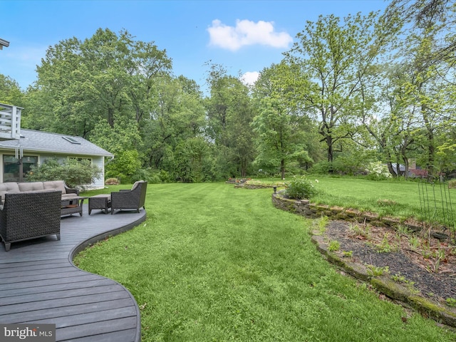 view of grassy yard with outdoor lounge area and a wooden deck
