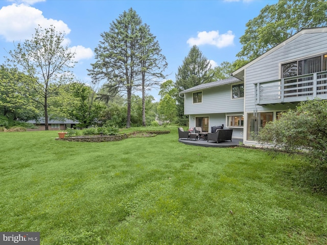 view of green lawn featuring an outdoor living space and a patio
