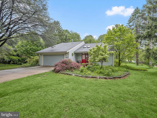 view of front of house with a garage, a front yard, and concrete driveway