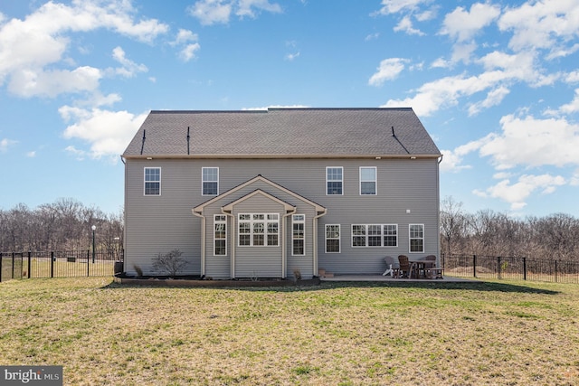 back of property with a lawn, a patio area, and a fenced backyard