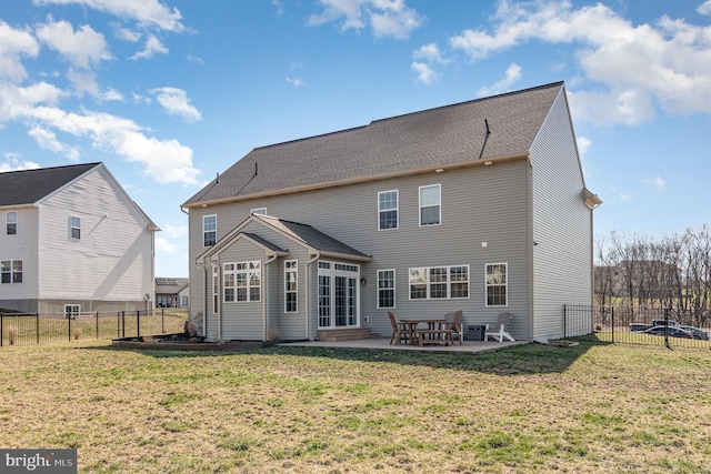 rear view of property with a lawn, a patio, and a fenced backyard