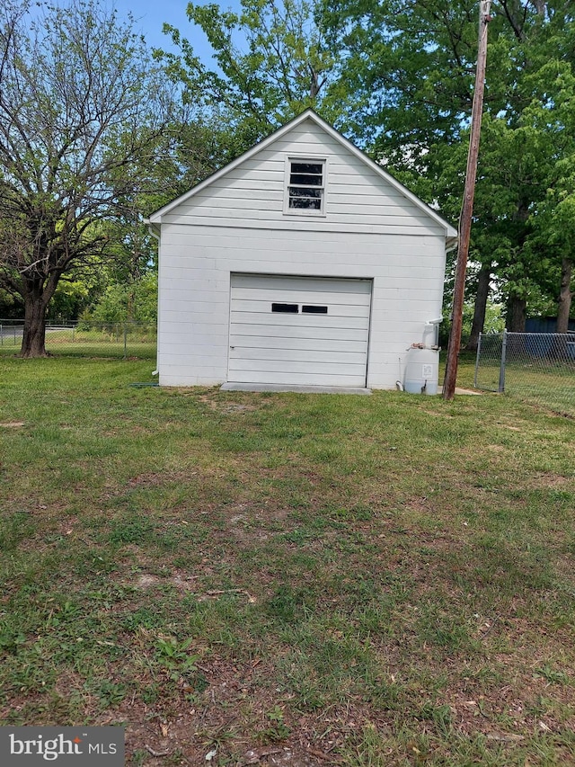 detached garage featuring fence