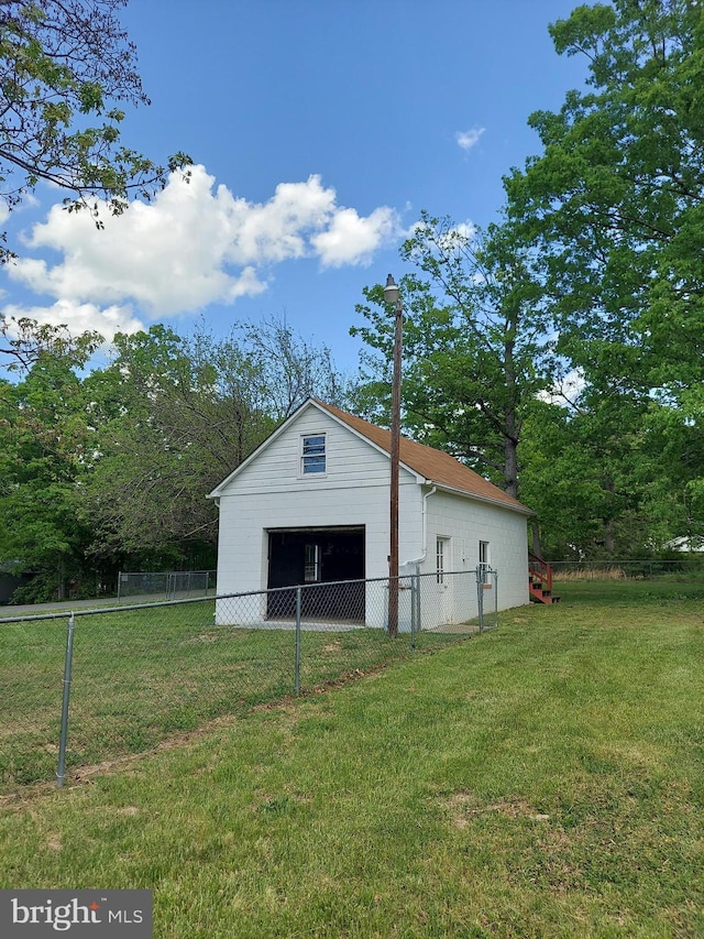 view of outbuilding featuring fence and an outdoor structure