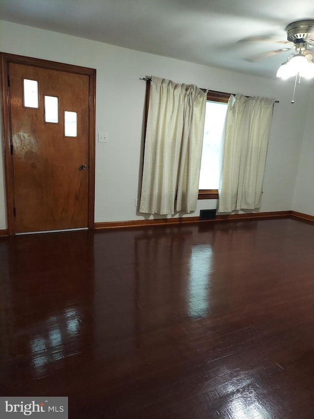 entrance foyer with baseboards, ceiling fan, and wood finished floors