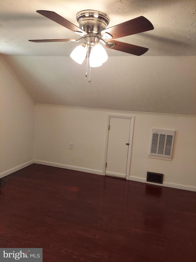 bonus room featuring a ceiling fan, visible vents, wood finished floors, baseboards, and lofted ceiling