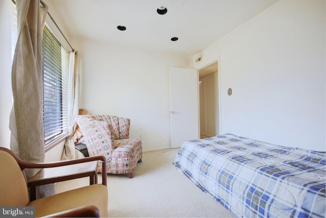 carpeted bedroom featuring visible vents