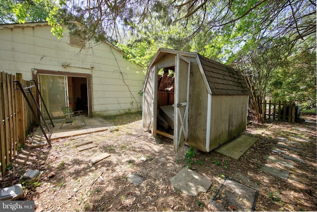 view of shed featuring fence