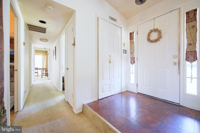 entryway featuring baseboards, visible vents, and plenty of natural light