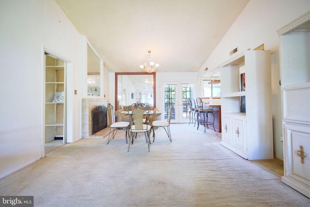dining room with visible vents, lofted ceiling, french doors, carpet, and a notable chandelier
