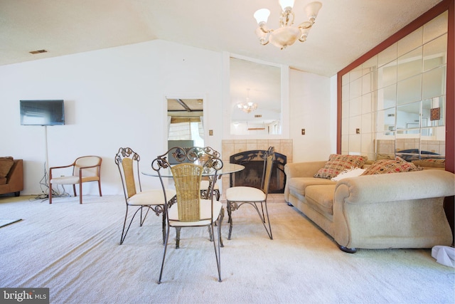 dining area with visible vents, carpet flooring, lofted ceiling, and a chandelier