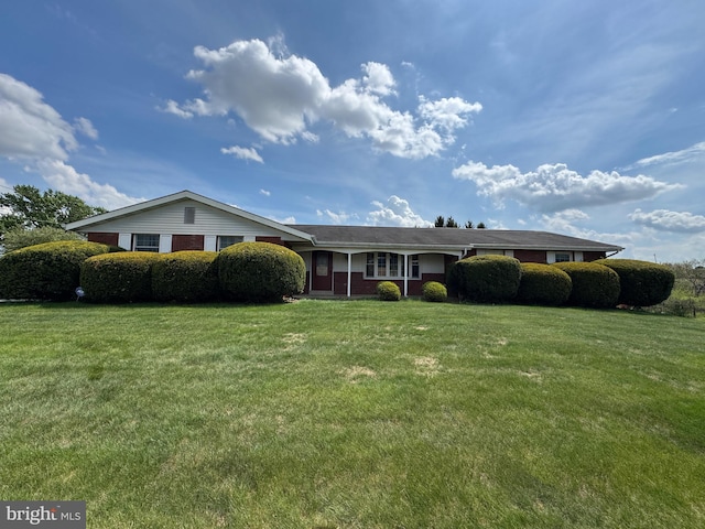 single story home featuring brick siding and a front yard