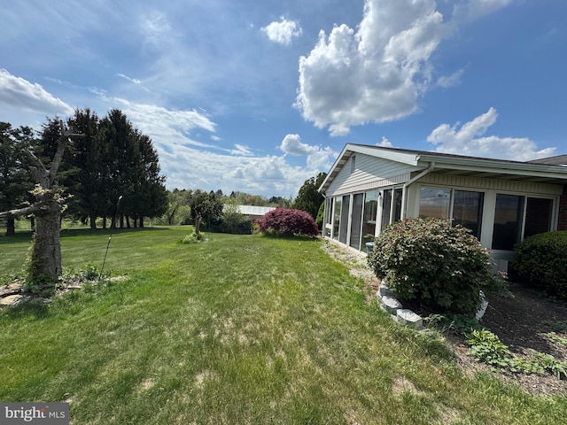view of yard with a sunroom