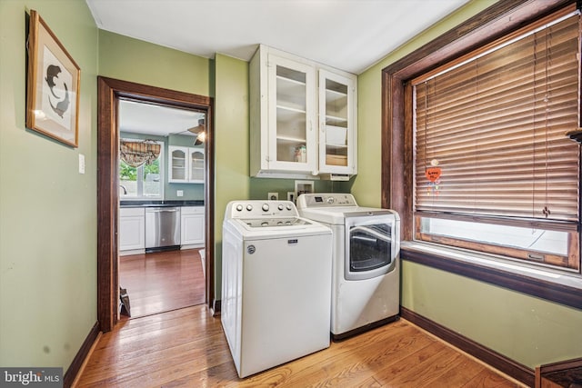 washroom featuring light wood-style floors, baseboards, and washer and dryer