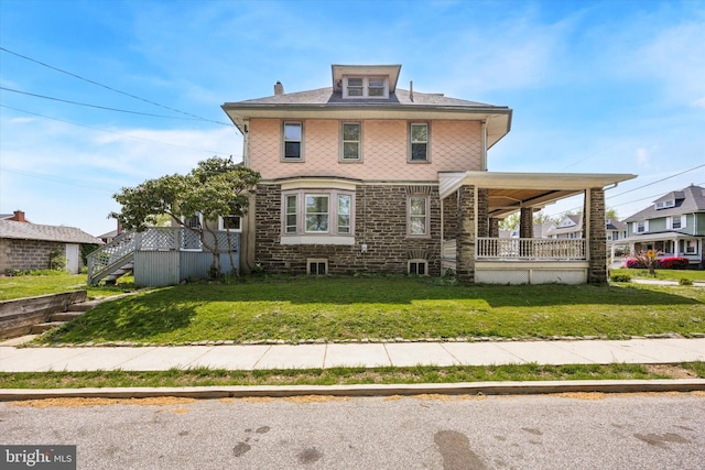 exterior space featuring a front lawn, covered porch, and stone siding