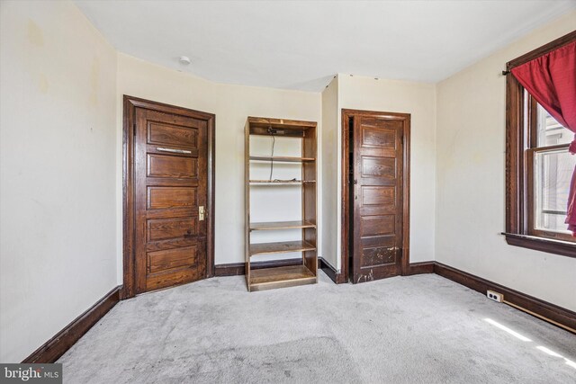 unfurnished bedroom with carpet floors and baseboards
