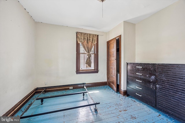 interior space with wood-type flooring and baseboards
