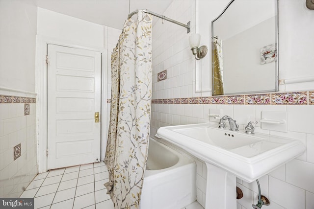 full bath featuring tile patterned floors, tile walls, and shower / tub combo with curtain